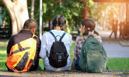 Asian students are sitting waiting to go to school.