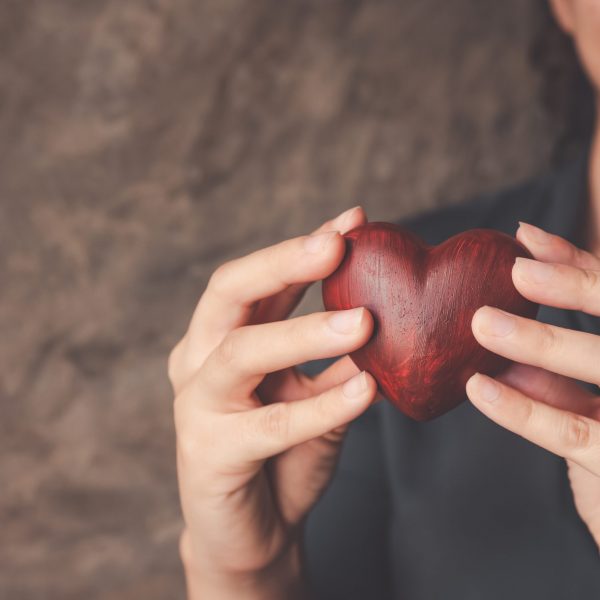 female hands holding red heart, world mental health day and world heart day, Life and health insurance, concept of love.